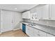 Bright, updated kitchen featuring granite counters, white cabinets, and new flooring at 920 State St, Shelbyville, IN 46176