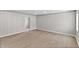 View of a living room with hardwood floors, beadboard walls, and white trim throughout the space at 920 State St, Shelbyville, IN 46176