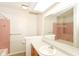 Bathroom featuring a single sink vanity, and a pink-tiled shower/tub at 9552 Maple Way, Indianapolis, IN 46268