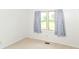 Bedroom featuring a window with curtains and carpeted floors at 9552 Maple Way, Indianapolis, IN 46268
