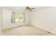 Neutral bedroom featuring a ceiling fan and window bringing in natural light at 9552 Maple Way, Indianapolis, IN 46268