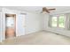 Bedroom featuring carpet, ceiling fan, window, and doorway to another room at 9552 Maple Way, Indianapolis, IN 46268