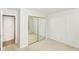 Bedroom featuring mirrored closet doors, carpeted floors, and neutral walls at 9552 Maple Way, Indianapolis, IN 46268