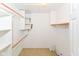 Walk-in closet with white shelving and wooden rods for maximum storage at 9552 Maple Way, Indianapolis, IN 46268