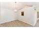 Bright dining room featuring wood-look floors and a modern light fixture at 9552 Maple Way, Indianapolis, IN 46268
