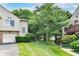 This home has a beautiful exterior with a lush lawn, mature trees, and a well-manicured landscape at 9552 Maple Way, Indianapolis, IN 46268
