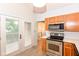 Kitchen featuring stainless steel oven/microwave and access to the backyard at 9552 Maple Way, Indianapolis, IN 46268