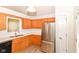 Kitchen with stainless steel appliances, oak cabinets, and white countertops at 9552 Maple Way, Indianapolis, IN 46268