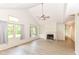 Bright living room featuring vaulted ceilings, large windows, a fireplace, and neutral flooring at 9552 Maple Way, Indianapolis, IN 46268