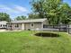 Spacious backyard featuring a lush green lawn and a trampoline, perfect for outdoor activities at 1039 Eastlawn Dr, Whiteland, IN 46184