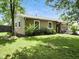 Picture of home's backyard, showing a well-maintained lawn, mature trees, and exterior of home at 1039 Eastlawn Dr, Whiteland, IN 46184