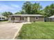 Home exterior showcasing back of the house, swing, green grass and blue sky at 1039 Eastlawn Dr, Whiteland, IN 46184