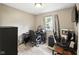 Office bedroom features wood-look floors, a window, and dedicated workspaces at 1039 Eastlawn Dr, Whiteland, IN 46184