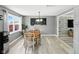 Cozy dining area featuring hardwood floors, natural lighting, and contemporary artwork at 1039 Eastlawn Dr, Whiteland, IN 46184