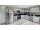 Stylish kitchen with gray cabinets, stainless appliances, and stone backsplash at 1039 Eastlawn Dr, Whiteland, IN 46184