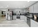 Charming kitchen boasts gray cabinetry, stone backsplash, and stainless appliances at 1039 Eastlawn Dr, Whiteland, IN 46184
