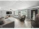 Open living room with stone accent wall, plush seating, and contemporary decor at 1039 Eastlawn Dr, Whiteland, IN 46184