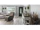 Bright living room featuring hardwood floors, neutral walls, and modern furniture at 1039 Eastlawn Dr, Whiteland, IN 46184