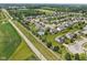 Expansive aerial view showcases the neighborhood with manicured lawns, mature trees, and a community pool at 10716 Patoka Rd, Indianapolis, IN 46239
