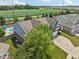 Aerial view of home with a swimming pool surrounded by lush green trees and a spacious lawn at 10716 Patoka Rd, Indianapolis, IN 46239