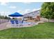 View of a spacious backyard with a gunite swimming pool, patio furniture, and fenced perimeter at 10716 Patoka Rd, Indianapolis, IN 46239