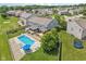Expansive backyard showcasing a sparkling pool, a large patio area, mature landscaping and a trampoline at 10716 Patoka Rd, Indianapolis, IN 46239