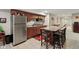 Basement kitchenette with stainless steel refrigerator, granite countertops, and bar seating, great for entertaining at 10716 Patoka Rd, Indianapolis, IN 46239