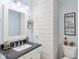 Charming half bath features a white wood wall, granite countertop, and stylish fixtures at 10716 Patoka Rd, Indianapolis, IN 46239