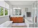 Bright bathroom with double sink vanity, soaking tub, and a large window with a view at 10716 Patoka Rd, Indianapolis, IN 46239