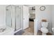 Bathroom with glass-enclosed shower and open doorway that leads to bedroom at 10716 Patoka Rd, Indianapolis, IN 46239