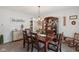 Dining area featuring a wooden table, elegant chandelier, and a vintage china cabinet in a bright space at 10716 Patoka Rd, Indianapolis, IN 46239