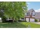 Attractive two-story home with brick and siding, featuring a covered porch and well-maintained landscaping at 10716 Patoka Rd, Indianapolis, IN 46239