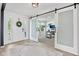 Bright foyer featuring sliding barn doors leading to an office with hardwood floors and modern decor at 10716 Patoka Rd, Indianapolis, IN 46239