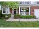Inviting front porch with white columns, a charming porch swing, and meticulously maintained landscaping at 10716 Patoka Rd, Indianapolis, IN 46239