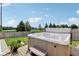 Hot tub on a wood deck and paver stone border surrounded by a green, well maintained lawn at 10716 Patoka Rd, Indianapolis, IN 46239