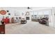 Bright living room with neutral colored walls, plush sofas, fireplace, and large windows for natural light at 10716 Patoka Rd, Indianapolis, IN 46239
