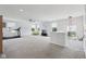 Spacious living room with multiple windows, ceiling fan, carpet floors and a treadmill at 10716 Patoka Rd, Indianapolis, IN 46239