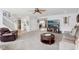 Open-concept living room features neutral decor, fireplace, carpeted floor, staircase, and adjacent dining area at 10716 Patoka Rd, Indianapolis, IN 46239