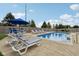 View of a gunite swimming pool with various patio furniture and a well maintained lawn at 10716 Patoka Rd, Indianapolis, IN 46239