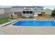 View of a backyard with an in-ground pool, hot tub, screened in porch and basketball hoop at 10716 Patoka Rd, Indianapolis, IN 46239