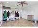 Room features a ceiling fan, tile floors and large custom closet organizers with drawers at 10716 Patoka Rd, Indianapolis, IN 46239