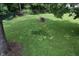 Lush backyard, flowers, and mature trees at 115 Northshore Blvd, Anderson, IN 46011