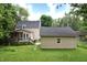 Backyard with detached garage, wood deck, and lush lawn at 115 Northshore Blvd, Anderson, IN 46011