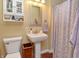 Cozy bathroom with a pedestal sink, toilet, and linen cabinet for storage at 115 Northshore Blvd, Anderson, IN 46011