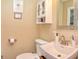 Traditional bathroom featuring a pedestal sink, toilet, medicine cabinet, and decorative mirror at 115 Northshore Blvd, Anderson, IN 46011