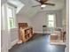 Sloped bedroom with hardwood floors, bright windows, ceiling fan and sitting area at 115 Northshore Blvd, Anderson, IN 46011