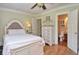 Light and airy bedroom with ensuite bathroom, white furniture, and hardwood floors at 115 Northshore Blvd, Anderson, IN 46011