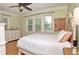 Comfortable bedroom with white bed, ceiling fan, and lots of natural light from the windows at 115 Northshore Blvd, Anderson, IN 46011
