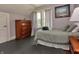 Cozy bedroom with sloped ceilings, dark floors, natural light and a wooden dresser at 115 Northshore Blvd, Anderson, IN 46011