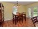 Comfortable dining area with wooden furniture and views of the outdoors through the doors at 115 Northshore Blvd, Anderson, IN 46011